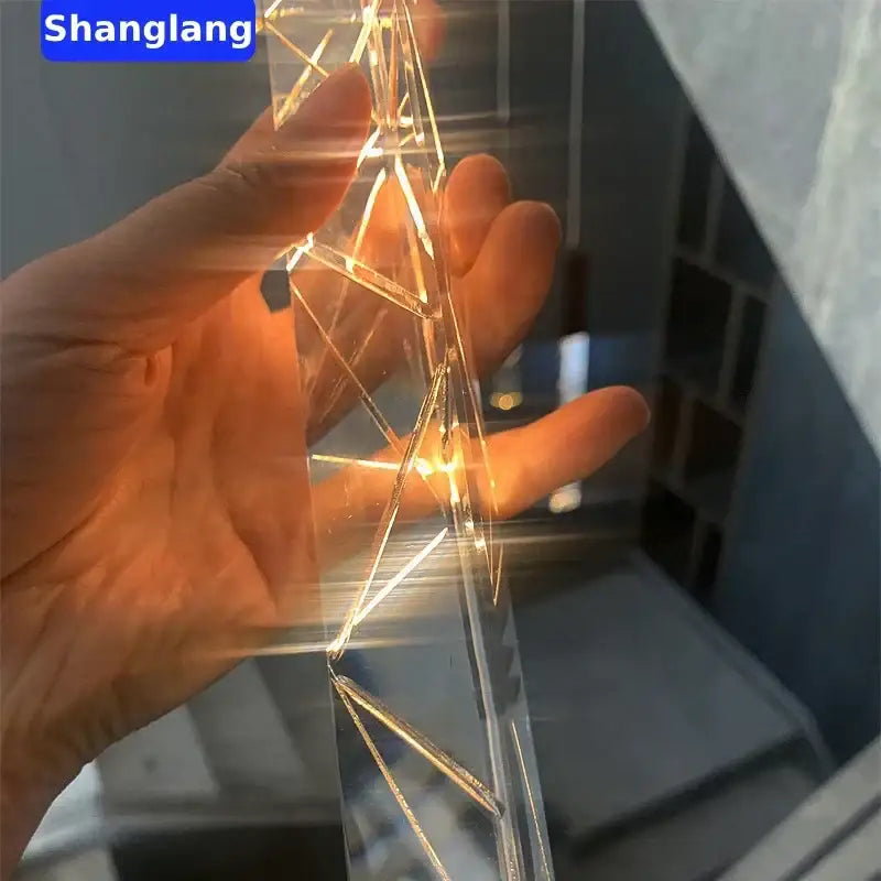 Modern geometric crystal chrome led chandelier featuring clear acrylic geometric light string with golden wire accents