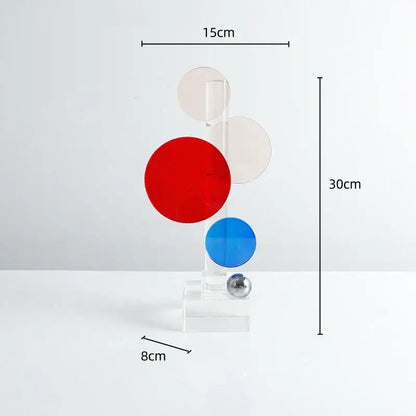 A modern geometric crystal circle sculpture with red blue discs and acrylic stand for home decor by decorbites