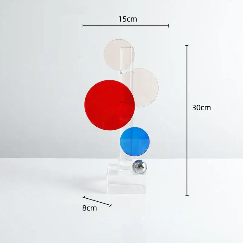 A modern geometric crystal circle sculpture with red blue discs and acrylic stand for home decor by decorbites