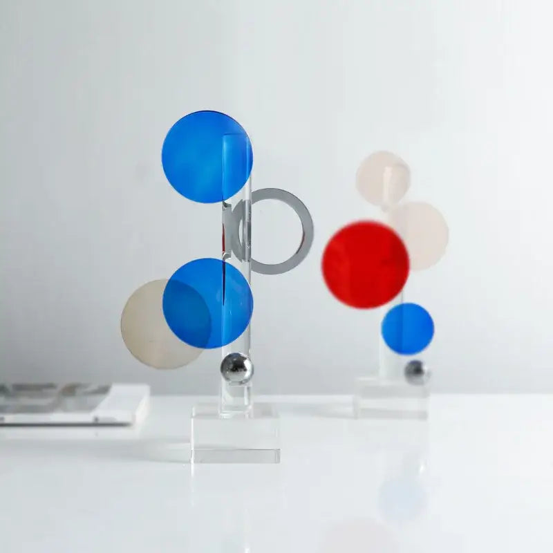 Modern geometric crystal circle sculpture with translucent blue red and beige spheres on clear acrylic rods for home decor