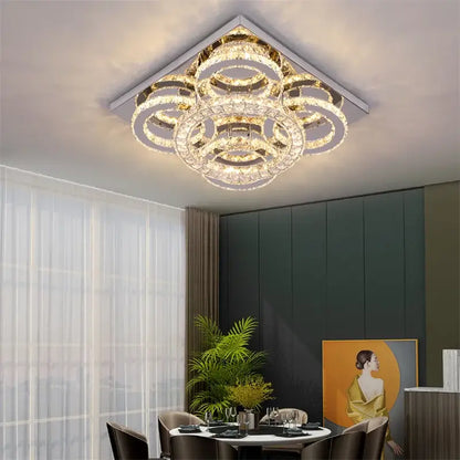 A modern geometric smart led chandelier ceiling light with concentric crystal rings and gold-toned metallic frame by decorbites
