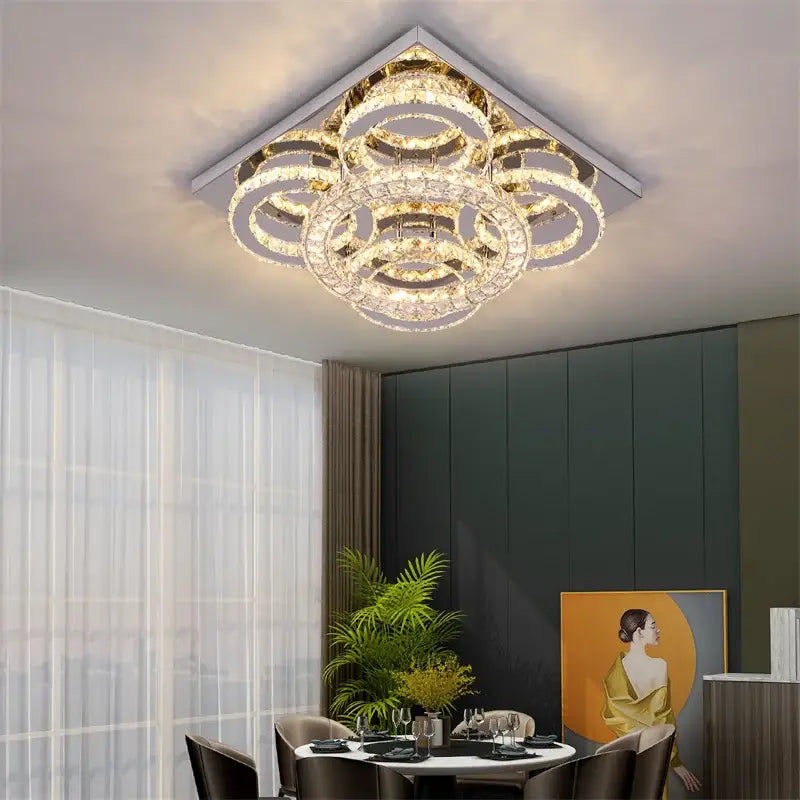 A modern geometric smart led chandelier ceiling light with concentric crystal rings and gold-toned metallic frame by decorbites
