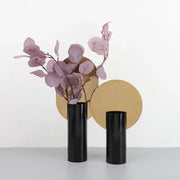 Two sleek black decorbites geometric cylinder vases hold delicate pink artificial flowers for living room decor