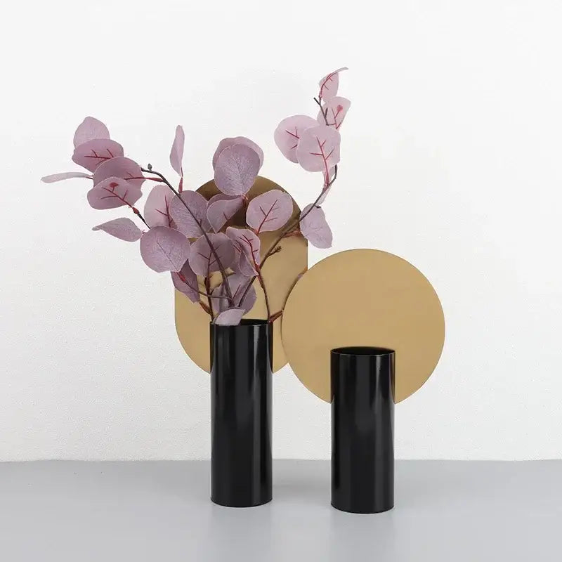 Two sleek black decorbites geometric cylinder vases hold delicate pink artificial flowers for living room decor