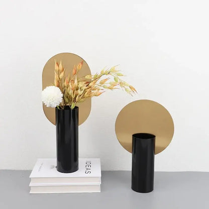 Black glossy geometric cylinder vases with dried artificial flowers and gold mirrors for modern decorbites living room decor