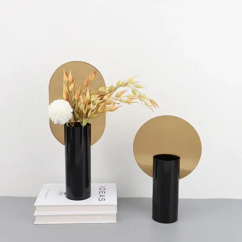 Black glossy geometric cylinder vases with dried artificial flowers and gold mirrors for modern decorbites living room decor