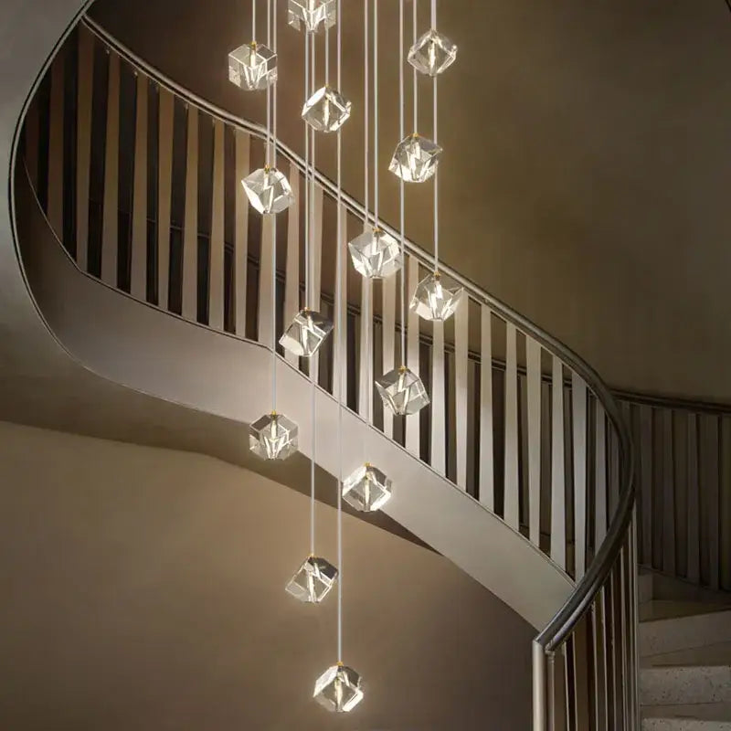 A modern decorbites crystal led chandelier with faceted geometric fixtures above a curved staircase light