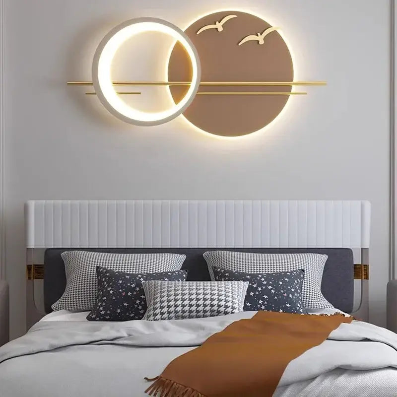 Modern geometric decorbites led wall sconce with glowing white ring warm backlit disc and gold bird silhouettes for bedroom