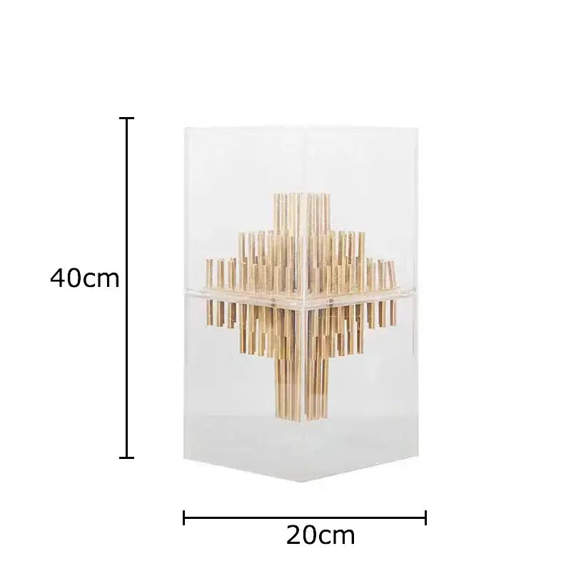 A modern geometric display box with a transparent acrylic cube housing golden bamboo sticks for living room decor