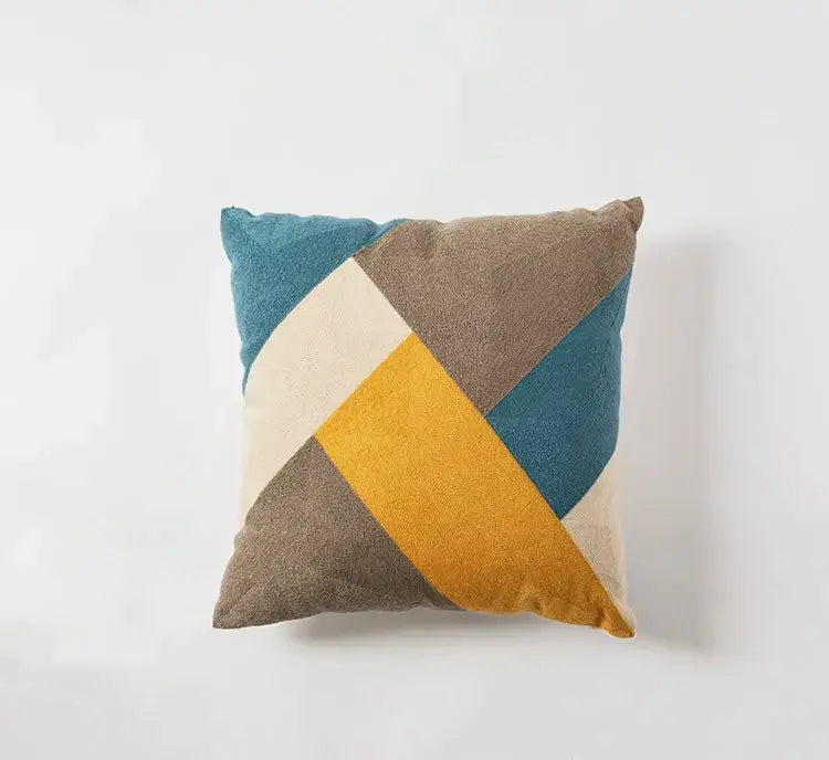 A modern geometric embroidery cushion cover with teal mustard yellow beige and taupe fabric panels for living room decorbites decor