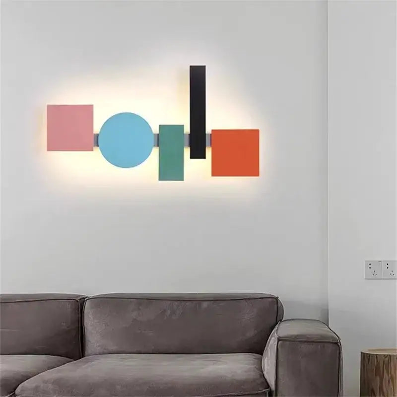 Modern geometric flush mount wall sconce with colorful flat panels in pink, light blue, teal, black, and orange for bedroom decor