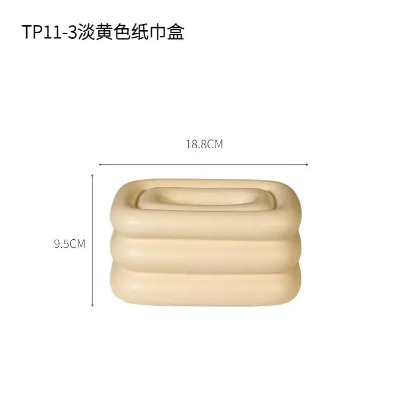 Beige three-tiered inflatable tissue box with soft texture and rounded edges for modern geometric fringe decorbites desktop use