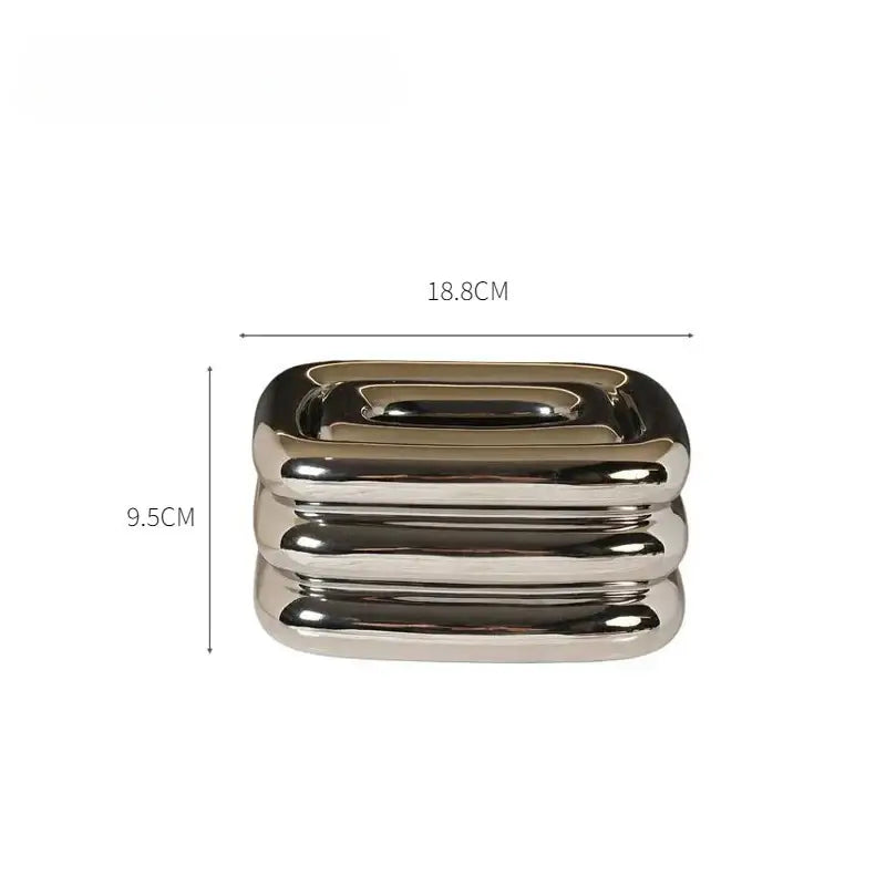 Modern geometric fringe chrome tissue box with shiny metallic rectangular shape and layered rounded edges for decorbites geometric fringe