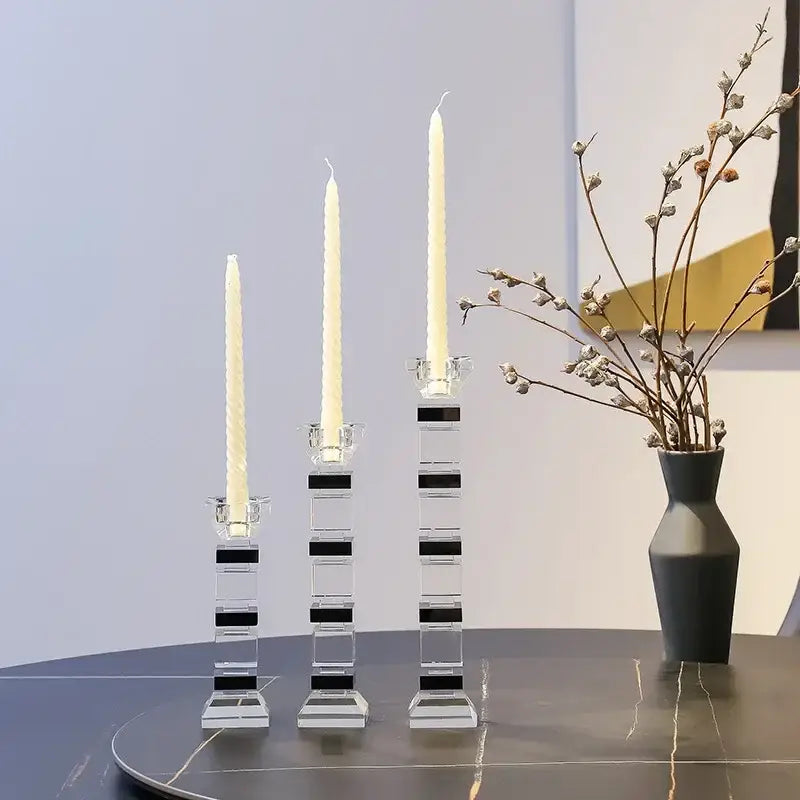 Modern geometric glass candle holder set with clear acrylic block design and black stripes holding white taper candles decorbites