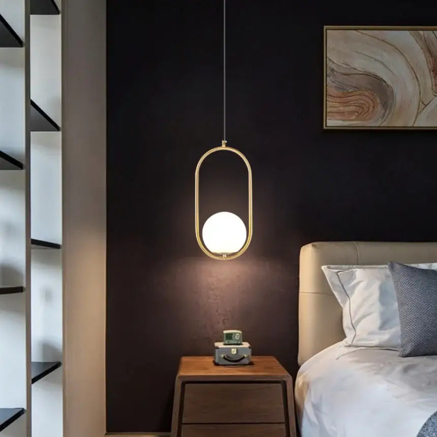 Modern gold-toned oval pendant light with frosted glass globe ideal for bedroom bedside glass pendant lights and chandeliers