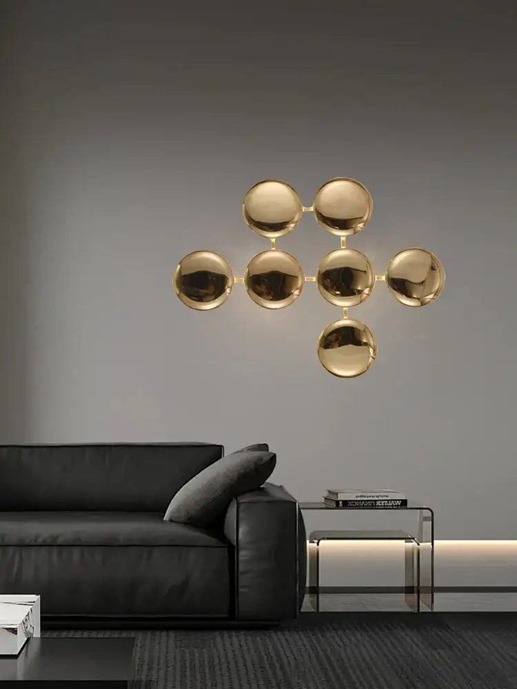 Gold-toned spherical wall sconces with a modern minimalist design featuring glossy gold led for living room decor