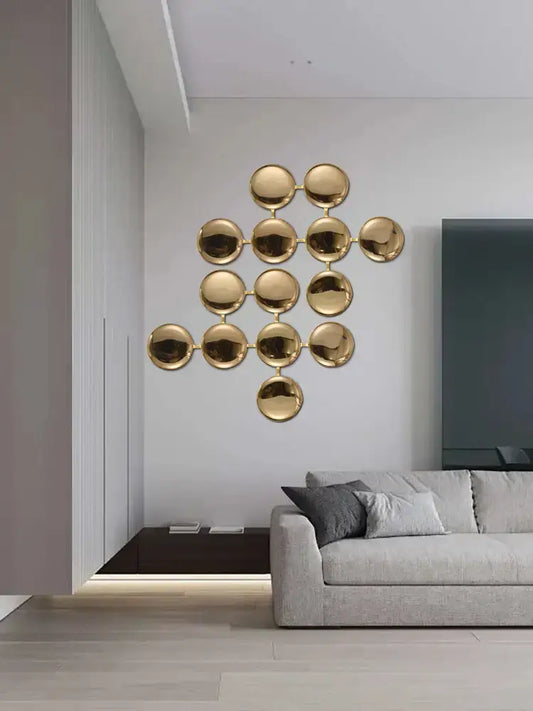Modern geometric glossy gold led wall sconces featuring gold-toned circular metal discs in a geometric pattern for living room decor