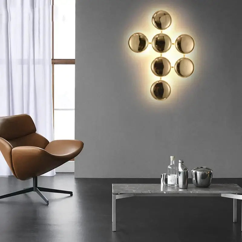 Modern geometric glossy gold led wall sconces featuring a gold-toned spherical minimalist design for living room decor