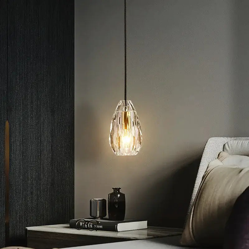 A modern geometric gold and clear crystal led ceiling chandelier with a warm glow suspended by a black cord decorbites crystal led