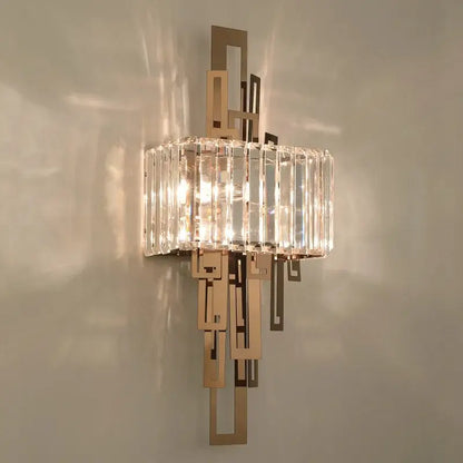 A modern geometric gold crystal wall lamp with brushed metal frame and vertical crystal rods for bedroom decorbites crystal wall use