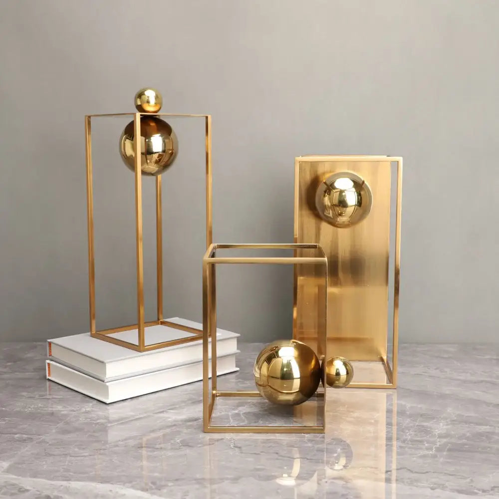 Modern geometric gold frame decorative figurines featuring gold-toned geometric sculptures with polished spheres for living room decor