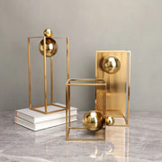 Modern geometric gold frame decorative figurines featuring gold-toned geometric sculptures with polished spheres for living room decor