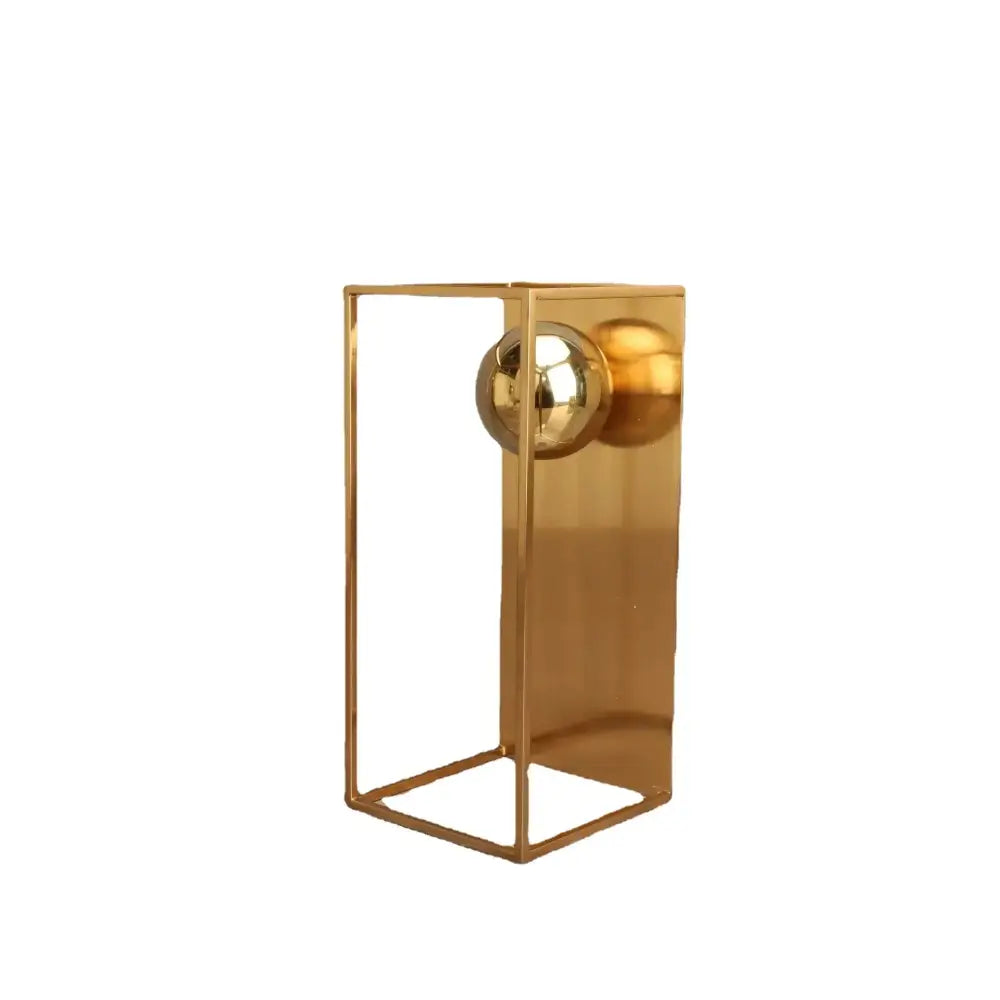 Modern geometric gold frame decorative figurines featuring a gold-toned geometric vase with reflective spherical accent