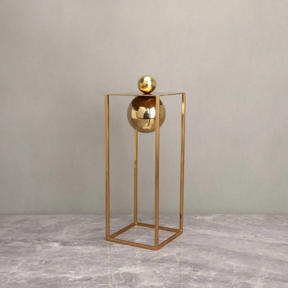 Modern geometric gold decorative figurines featuring two polished spheres within a minimalist geometric gold frame