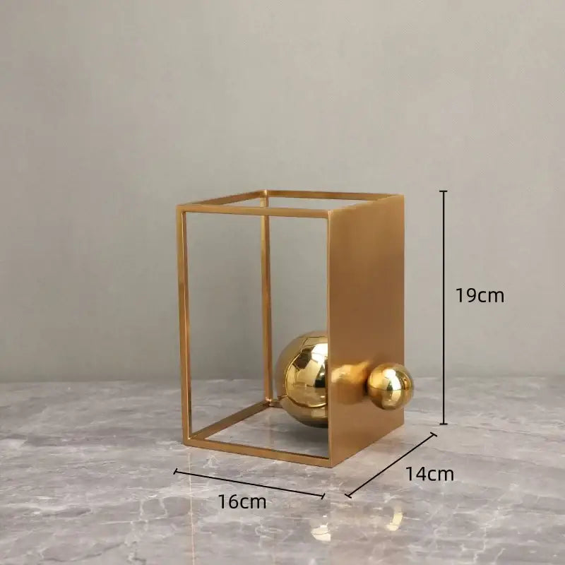 Modern geometric gold decorative figurines featuring a gold-toned metallic geometric gold frame with polished spheres