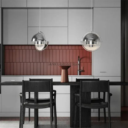 Two sleek spherical pendant lamps with polished chrome finish enhance modern geometric decorbites iron deformable pendant design