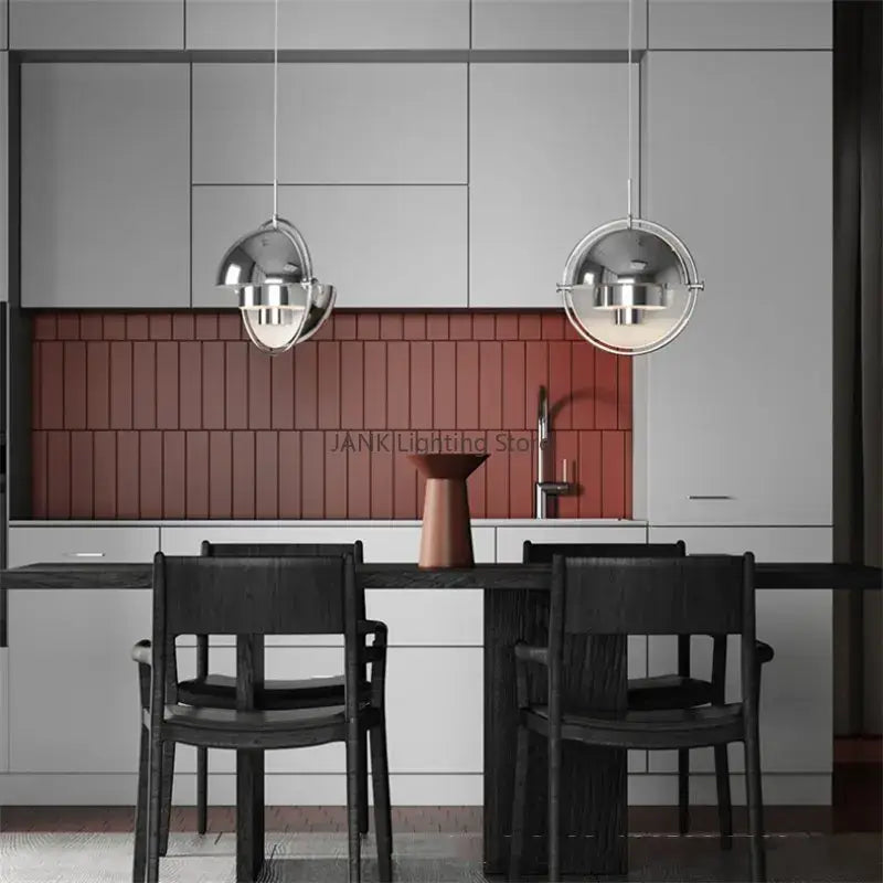 Two sleek spherical pendant lamps with polished chrome finish enhance modern geometric decorbites iron deformable pendant design