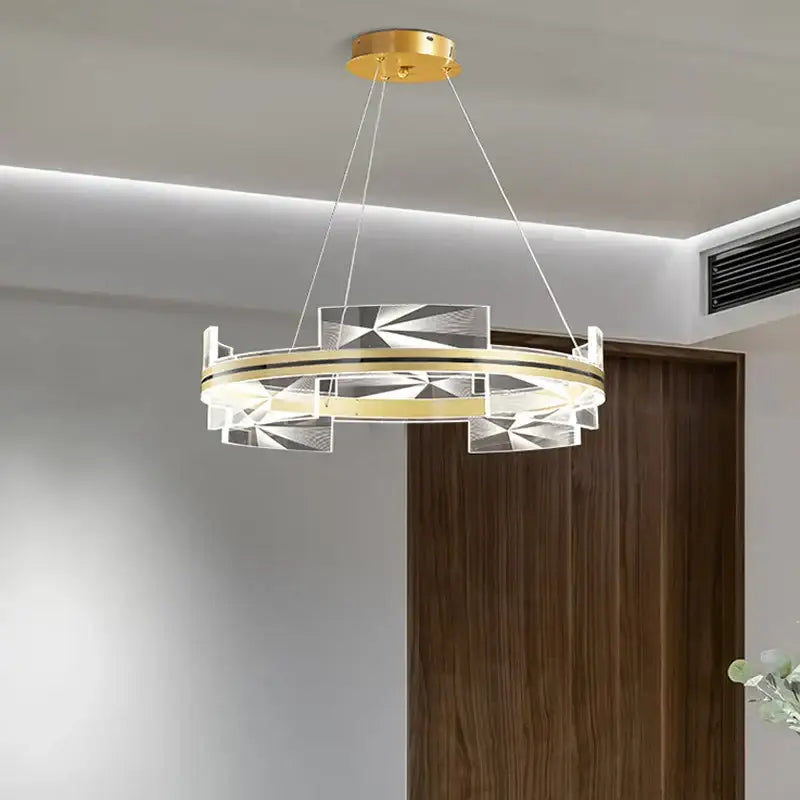 Modern geometric gold led pendant lights with gold-toned metal frame and clear acrylic panels for dining room decorbites decor