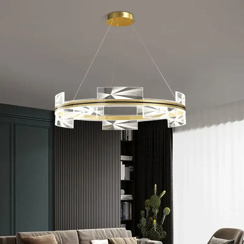Modern geometric gold led pendant lights featuring a circular gold-toned metal frame with clear crystal accents