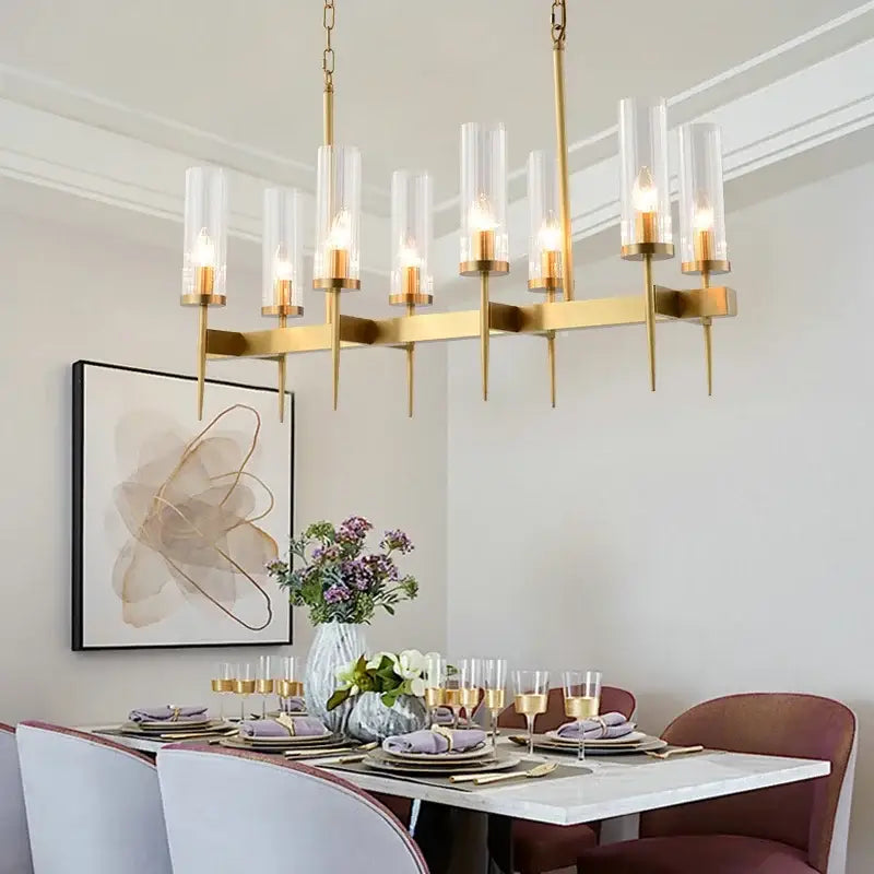 Modern geometric gold metal glass pendant light with gold-toned chandelier and clear cylindrical glass shades for dining room decorbites gold metal
