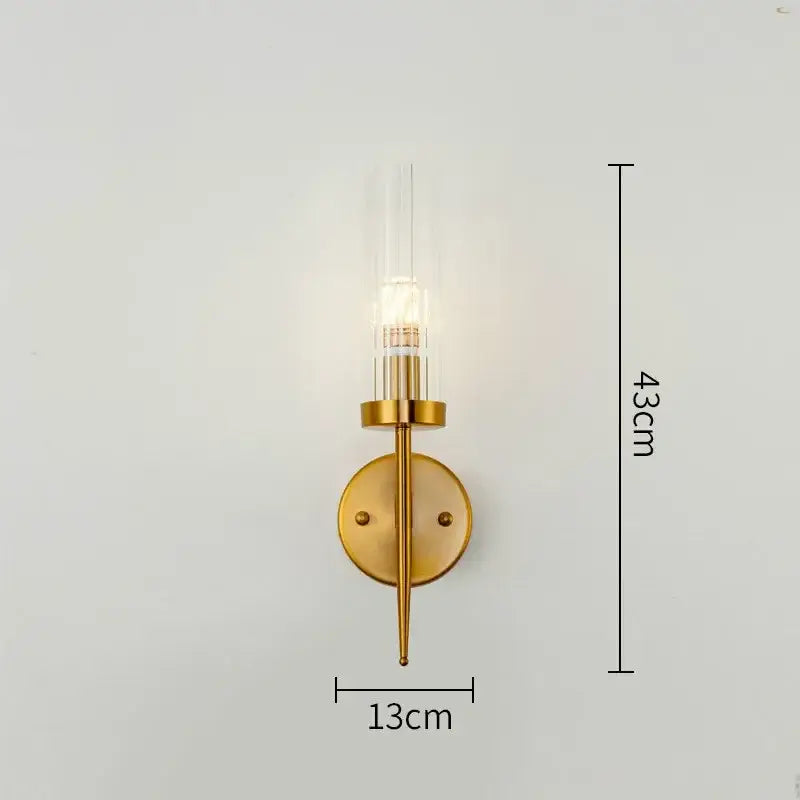 Modern geometric gold metal glass pendant light featuring a gold-toned wall sconce with illuminated bulb decorbites gold metal