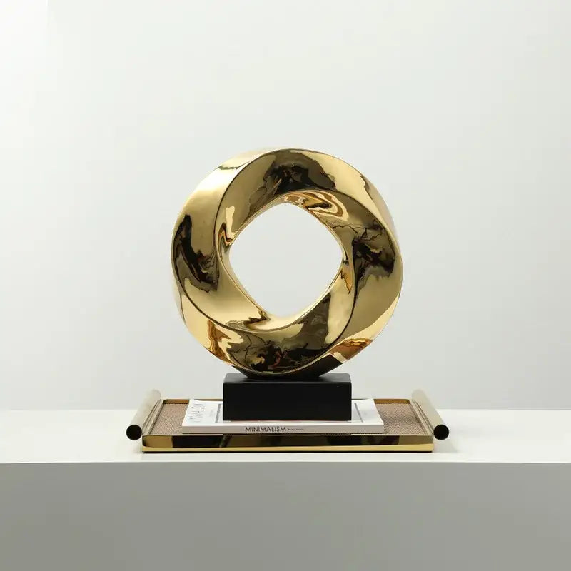 Shiny gold metallic abstract geometric gold ring hollow sculpture with twisted interlocking rings for living room decor