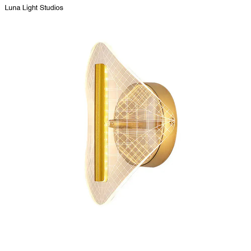 Modern geometric gold sconce light with a sleek angular design and illuminated grid pattern diffuser for living room use