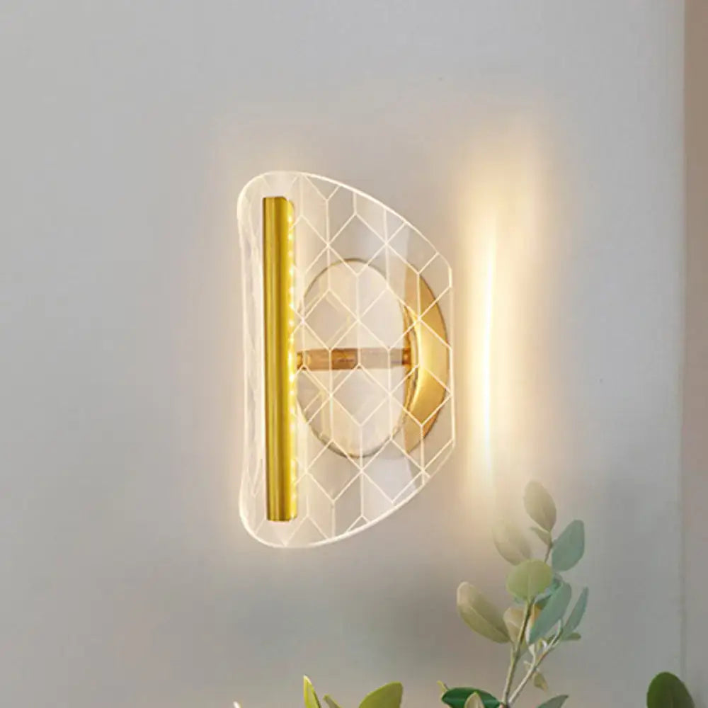 Modern geometric gold sconce light with translucent acrylic honeycomb pattern and polished gold metal fixtures for living room