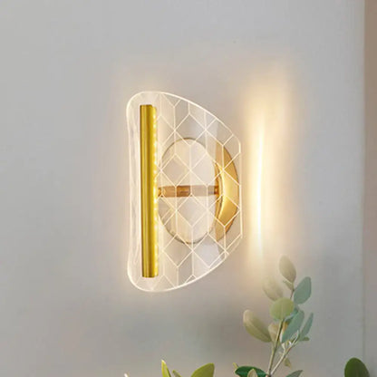 Modern geometric gold sconce light with translucent acrylic honeycomb pattern and polished gold metal fixtures for living room
