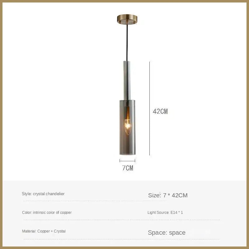 A sleek copper crystal led pendant light with cylindrical glass shade and exposed filament bulb for dining room decorbites