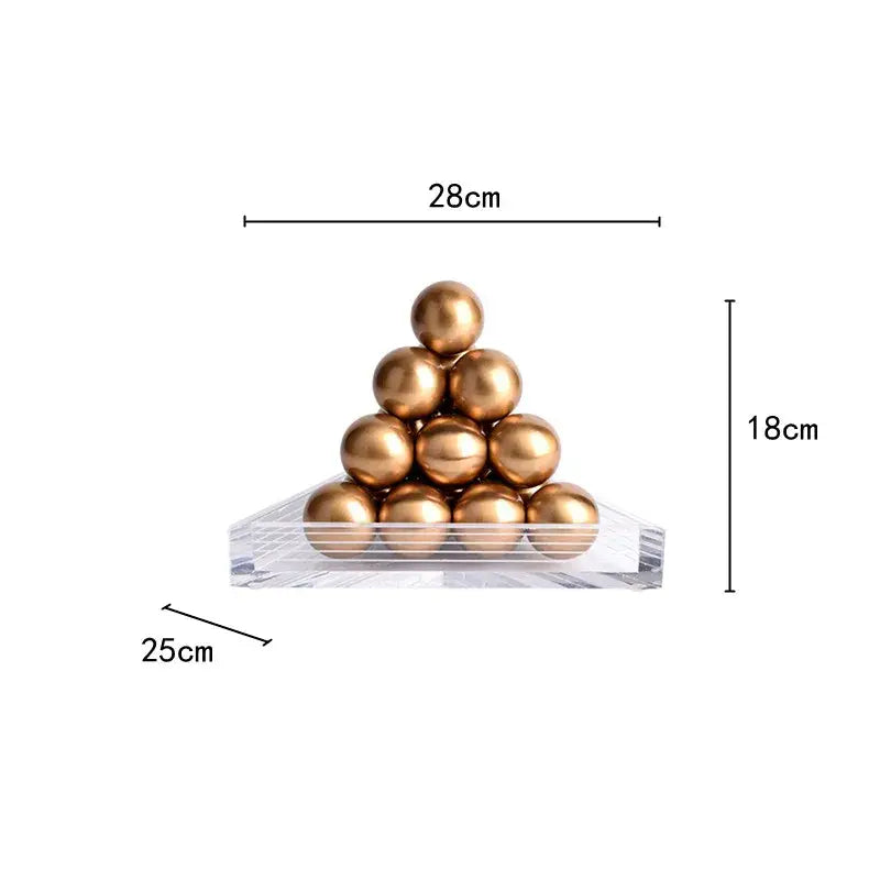 A modern geometric gold tower set featuring polished gold spheres on a clear acrylic base for living room decorbites geometric gold design
