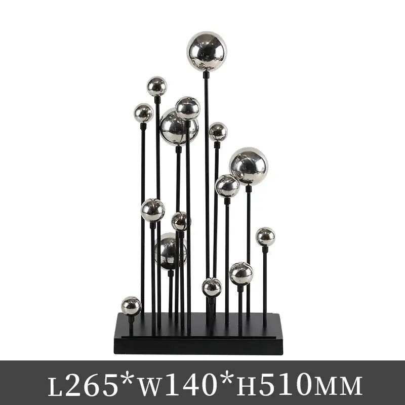 Modern geometric golden ball sculpture with varying sizes on black rods and base for living room metal decor