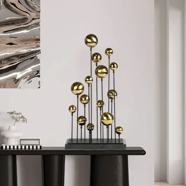 Modern geometric golden ball sculpture featuring polished gold spheres on black rods for living room decorbites decor
