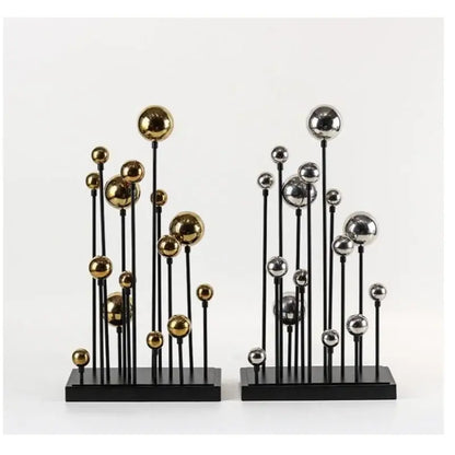 Modern geometric golden ball sculpture with metallic gold and silver orbs on black stems and bases for living room decor