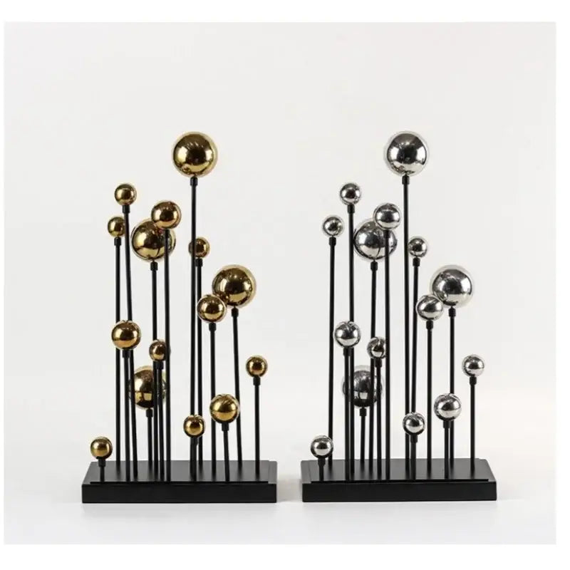 Modern geometric golden ball sculpture with metallic gold and silver orbs on black stems and bases for living room decor
