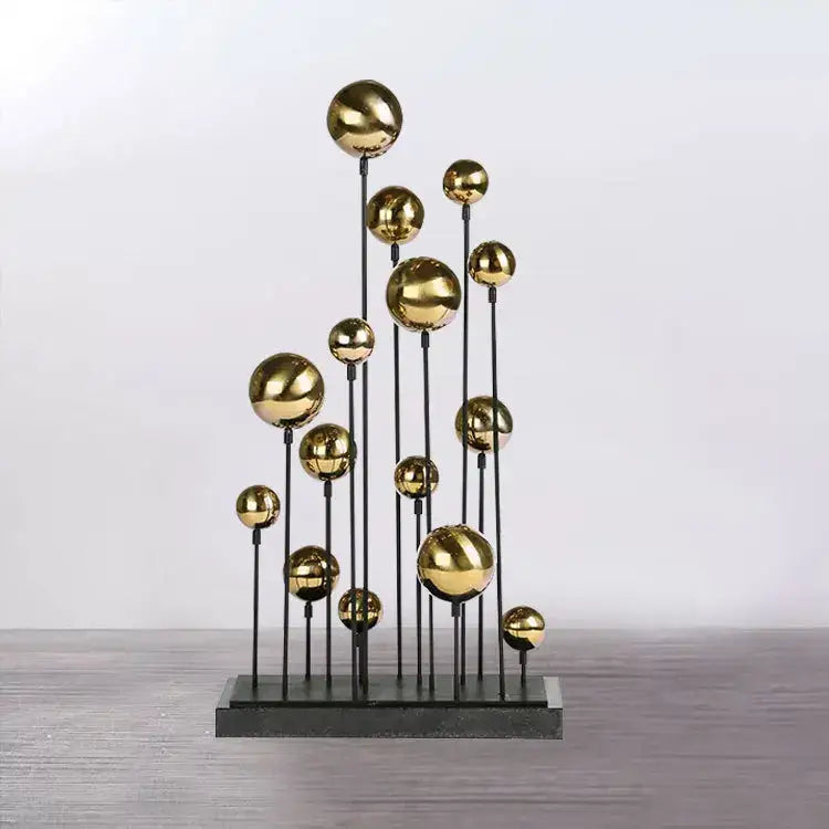 Modern metallic sculpture with polished gold spheres on black rods, a geometric golden ball sculpture for decorbites living room decor