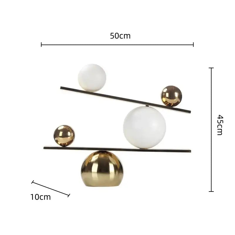 Modern geometric golden ball seesaw ramp living room sculpture with white and gold metallic spheres on black rods