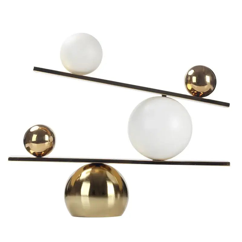 Modern geometric golden ball seesaw ramp sculpture with black metal rods and alternating matte white and polished gold spheres