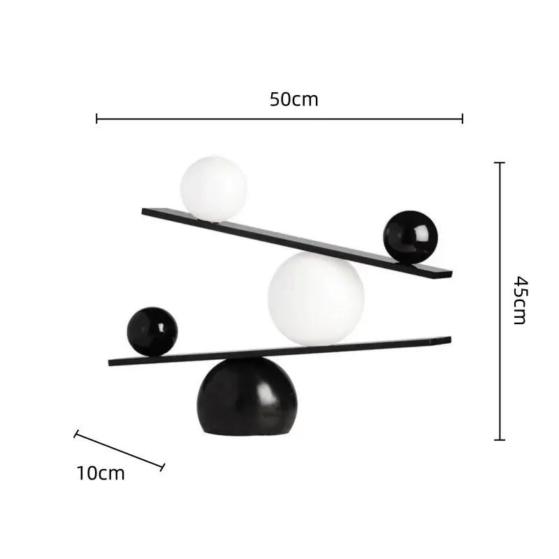 Modern geometric golden ball seesaw ramp sculpture with black and white spherical balance design for decorbites decor