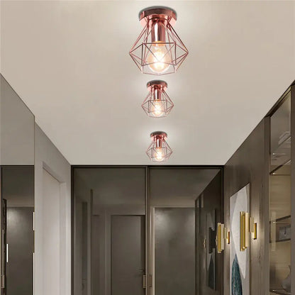 Three rose gold modern geometric ceiling lights with iron frame cage design featuring exposed bulbs for aisle and loft decorbites iron frame cage